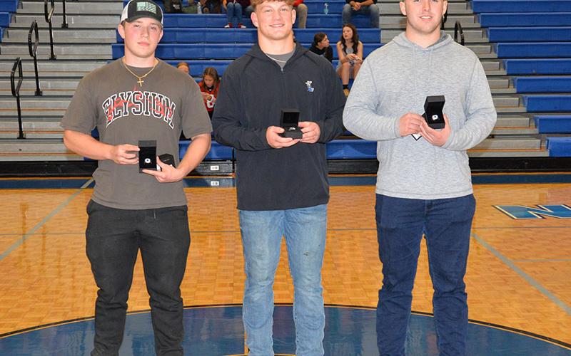 Sam McGill, Cooper Born and Case Holloway, from left, display the rings they received Tuesday night, December 17, honoring them as Georgia State Champion weightlifters.