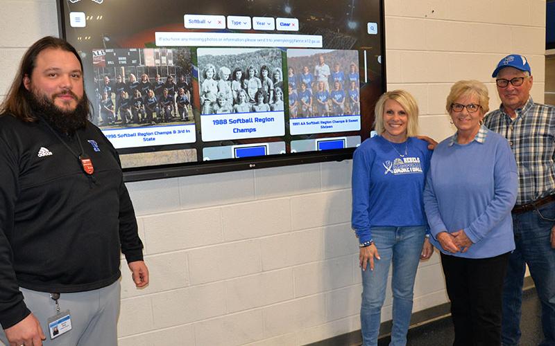 Fannin County High School Athletic Director Jeremy King, far left, showed the workings of the interactive screen displaying sports history to, from left, Kelly Ledford and Linda and Etheridge Ware.