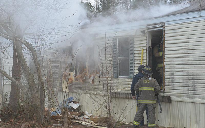 Fannin County firefighters had to tear out part of a wall of this mobile home off Austin Street in Blue Ridge to stop an early morning fire from spreading throughout the structure.