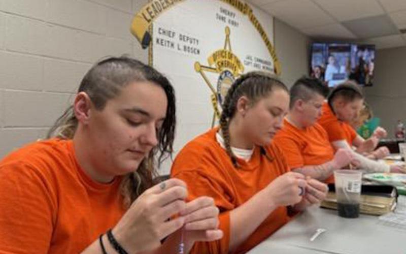 The ladies in the Fannin County Jail worked hard to make bracelets for the women and children of the Dominican Republic, making a total of 287. Making bracelets that carry messages including “Jesus Loves Me,” are, from left, Tamrah Hedden, Savannah Dillard, Tara Sharp and Haley Dillingham.