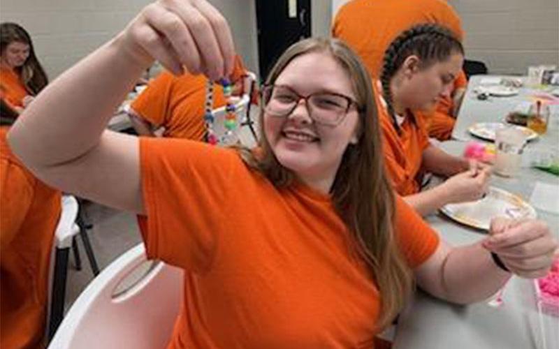 Abbigayle Ownes shows off a bracelet she made that will be given to a child in the Dominican Republic during a mission trip by members of The Ridge Community Church.