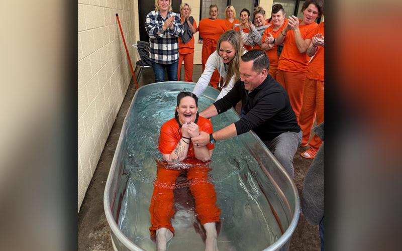 Erica Dean is shown being baptized by Rev. Dr. Chan Mitchell of The Ridge Community Church with the help of Kristen Young, one of the leaders of the Breaking Chains ministry sponsored by the church. Members of Breaking Chains visit the Fannin County Jail every week to “spread the love of Jesus,” Young says. Dean was one of several ladies in the Fannin County Jail to be baptized during a special service after professing their faith in Jesus Christ.