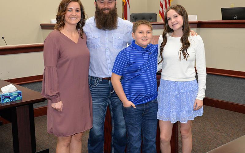 After taking his oath of office, new Fannin County school board Member Robert Patterson, second from left, is shown with his family, from left, Amber Patterson, Case Patterson and Lynnex Patterson.