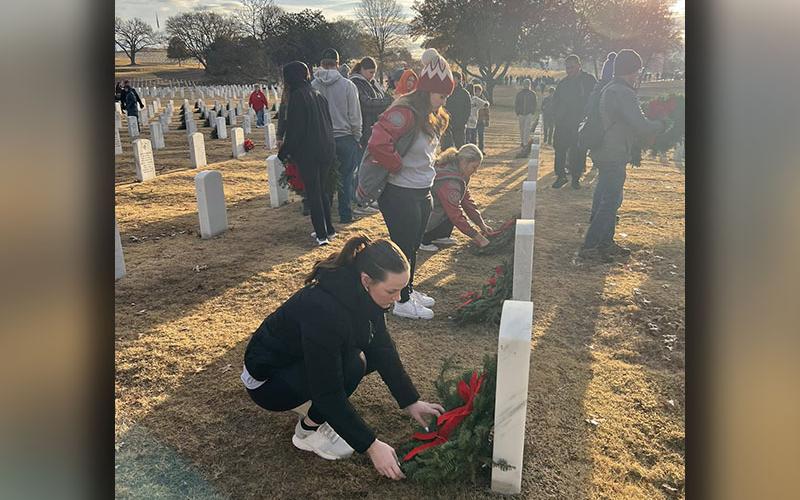 Copper Basin High School senior Samantha Ware is pictured as she places a wreath in memory of a fallen veteran at this year’s Wreaths Across America.