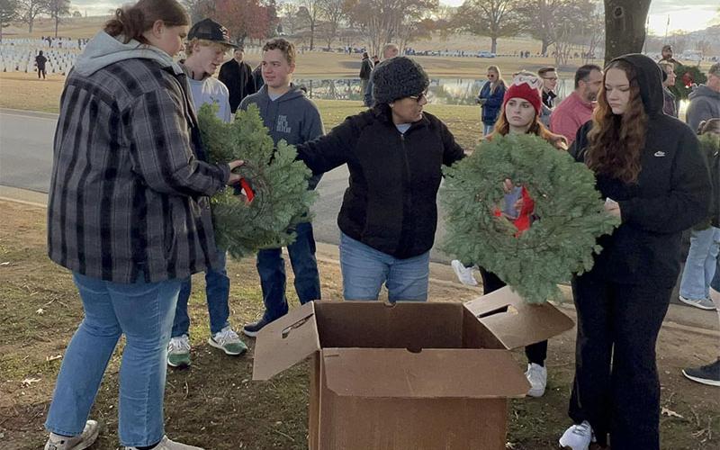 Each student collected a wreath to place during the Wreaths Across America service project that Copper Basin High School’s (CBHS) senior class attended. Pictured at the event, from left, are seniors Alyvia Harris, Malachi Kemper, Noah Thompson, CBHS Teacher Zulma Youngs who helped coordinate the project, seniors Anna Ballew and Nicole Kimsey.