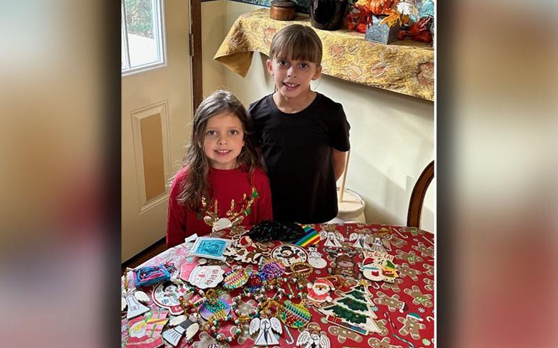 Nora and Sarah Miller are standing with some of the ornaments that were made for the victims that were affected by Hurricane Helene in Asheville, North Carolina. The ornaments were delivered December 5.