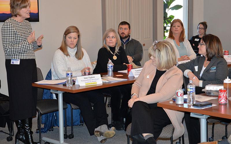 Fannin County School Superintendent Shannon Dillard, standing, gave an overview of the system’s progress during the Fannin County Chamber of Commerce &amp; CVB annual Board Orientation last week. Among that progress were improvements in College and Career Ready Performance Index test scores. Listening to Dillard are, from left, Gini Tipton, Tammie Mason, Dustin Queen and Sandy Ott.
