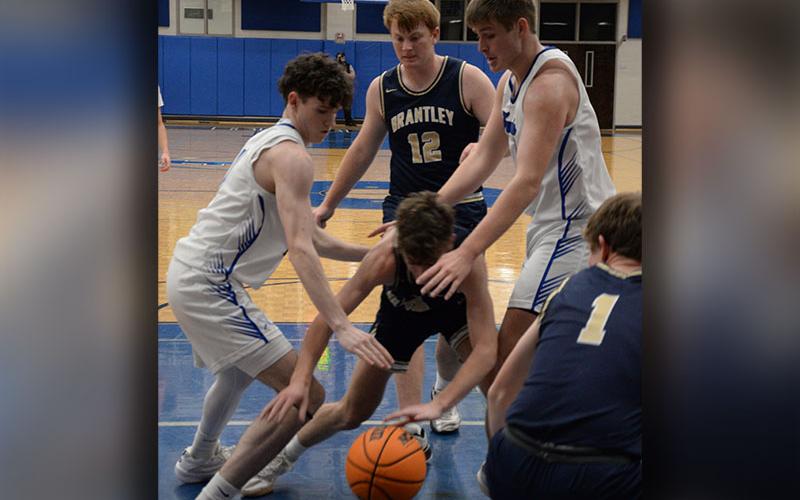 Brody Henson and Keaton Watkins fight for a loose ball in Rebel post season action.