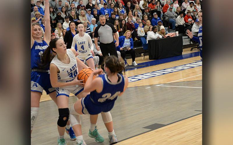 Avi Ethington fights against two Armuchee Lady Indians as she works for a shot Friday night in Calhoun.