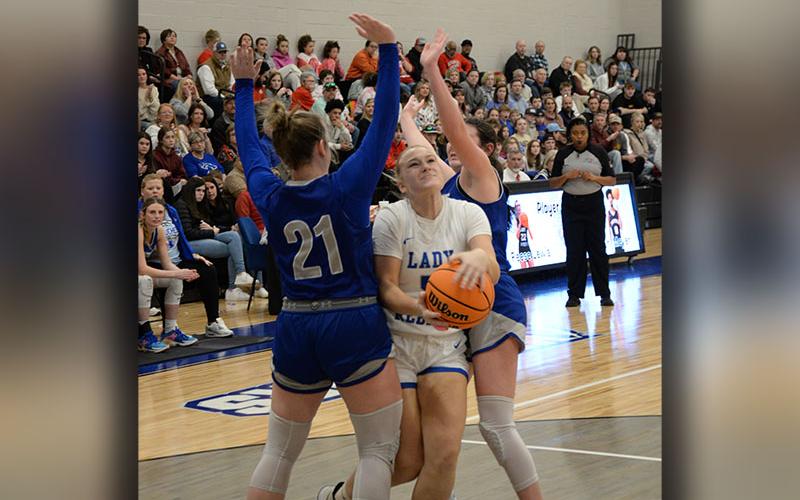 Callie Ensley fights her way between two defenders for the Fannin County Lady Rebels in post season action.