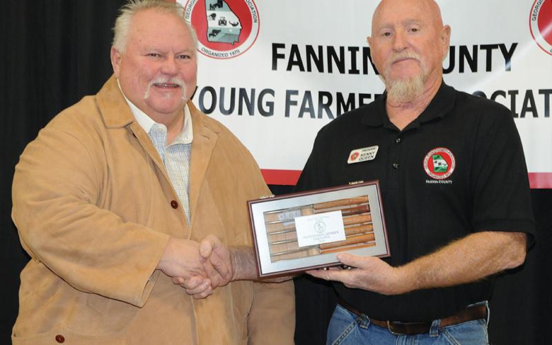 Greg Staffins, left, is presented with the Outstanding Member Award for 2024 during the Fannin County Young Farmers Association’s Awards Banquet Friday, January 24. Association President Kenny Queen presents the award.