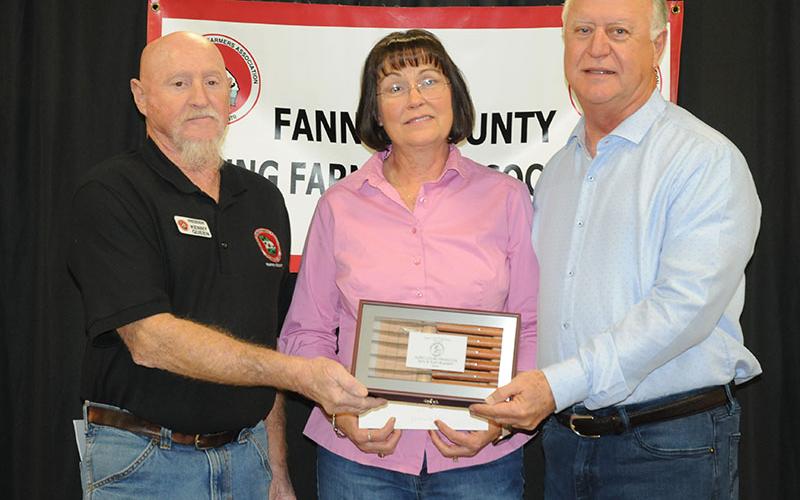 Ruth, center, and Terry Bramlett, right, receive the Ag Producer Award during the Fannin County Young Farmers Association’s Awards Banquet Friday, January 24. President Kenny Queen presents the award.