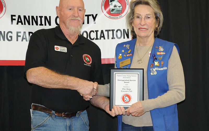 Kiwanis Club of Blue Ridge member Marie Traylor accepts the Distinguished Service Award on behalf of the club during the Fannin County Young Farmers Association’s Awards Banquet Friday, January 24. She is shown with association President Kenny Queen.