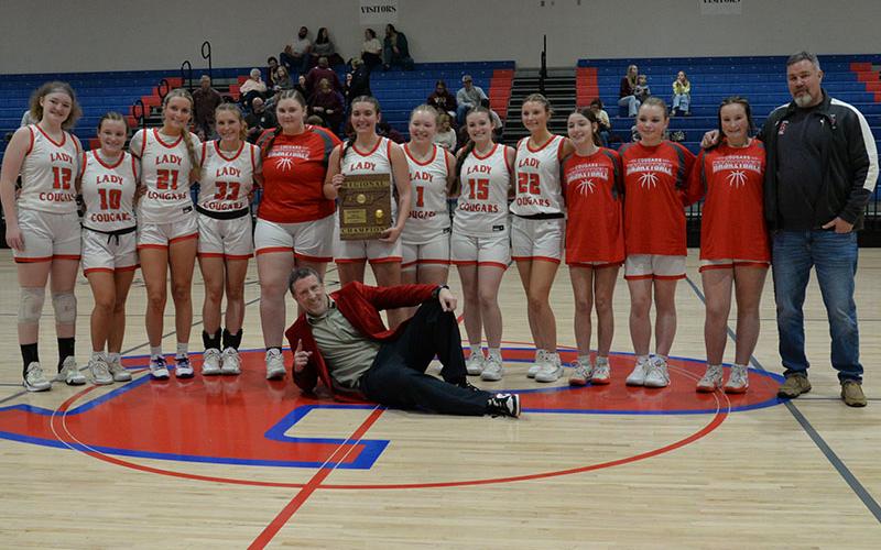 Copper Basin High School’s Lady Cougars and their coaches show off their Region Championship trophy after defeating Van Buren High School for the title last Wednesday night, March 5, at Polk County High School.