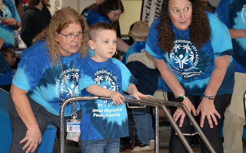 Graceson Dills gets encouragement from Traci Kropewnicki (left) and Susan Jones from East Fannin Elementary.