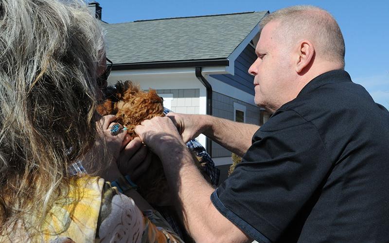 Fannin County Animal Control Officer Luke McDonald is shown microchipping a dog at the Barking Buddies free vaccine clinic.