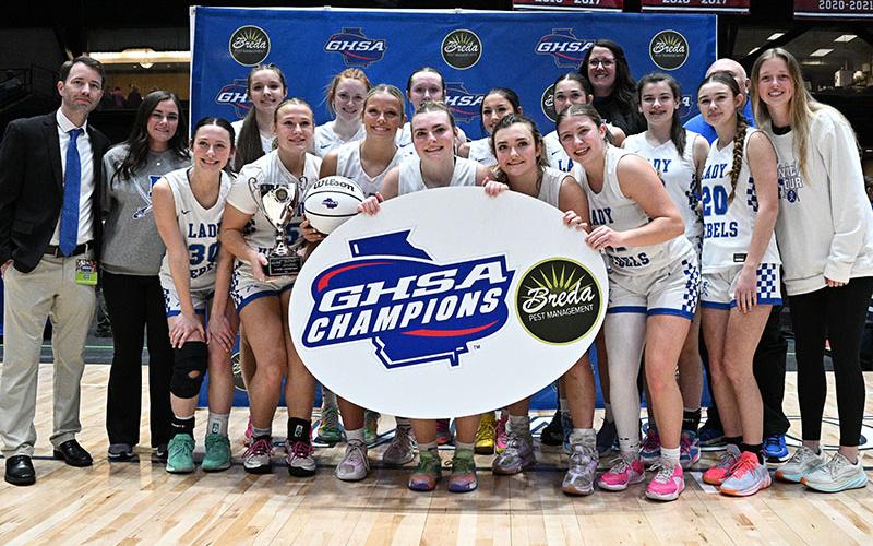 Photo courtesy All Star Photos Shown after their Saturday win in the Macon Coliseum are, from left, front, Avi Ethington, Callie Ensley, Emma Holloway, Maggie Ledford, Reese Lewis, and Izzie Jabaley; and, back, Head Coach Ryan Chastain, Assistant Coach Jenna Young, Brooklyn Owenby, Albany Cole, Emma Buchanan, Saige Turner, Sadie Patton, Assistant Coach Megan Orton, Toccoa Hampton, Assistant Coach Randy Hallmark (hidden), Kendall Gaddis and Assistant Coach Morgan Holt.
