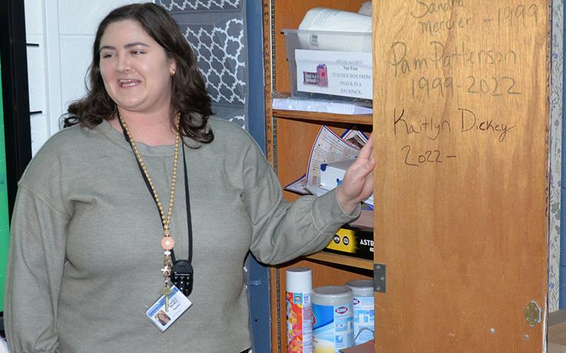 Fannin County English teacher Kaitlyn Davis showed Leadership Fannin members the inside of a cabinet door in her classroom with the names of the teachers in whose footsteps she follows, Sandra Mercier and Pam Patterson.