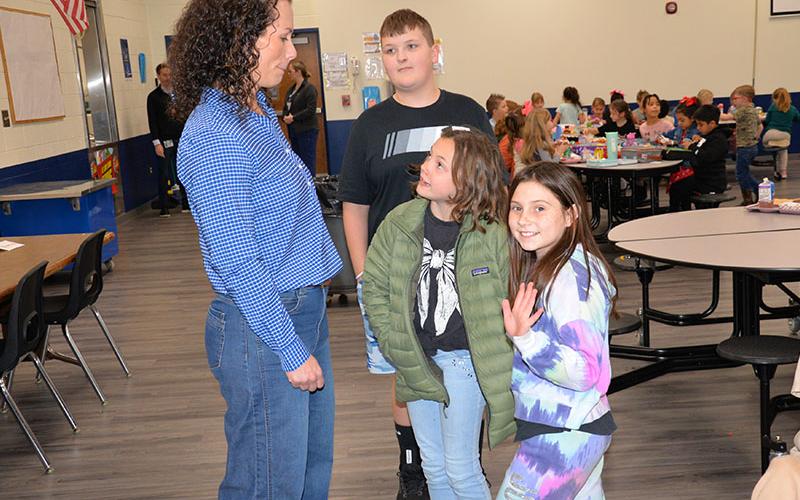 Fannin County Board of Education member Ashley H. Weeks visits with Blue Ridge Elementary School students, from left, Izaiah Bradburn, Charleigh Brown and Arianna Crowder.