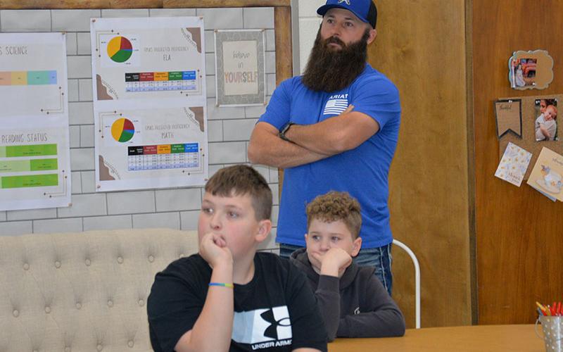 School board member Robert Patterson is joined by, seated, Izaiah Bradburn (left) and Brantley Barton.