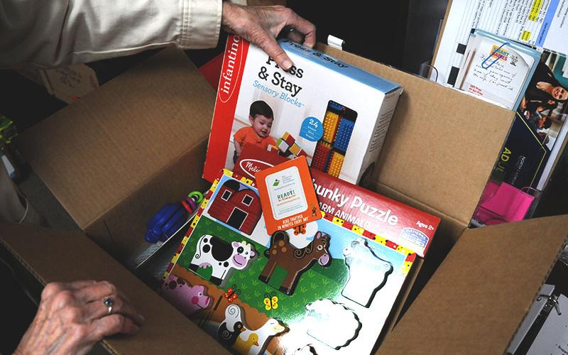 The Craddock Center’s Smart Babies program coordinator, Bev Cook, displays a box of gifts for parents who take part in the program.