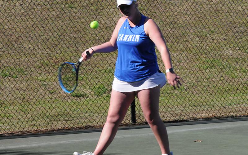 Junior Kendall Clore lines up her return in a March 18 home tennis game.