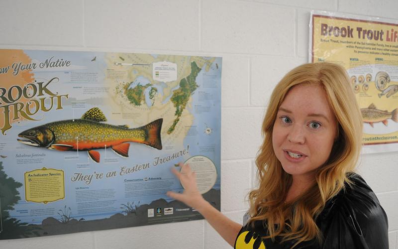 Blue Ridge Elementary School BRES) STEM teacher Tori Arp points to a brook trout poster.