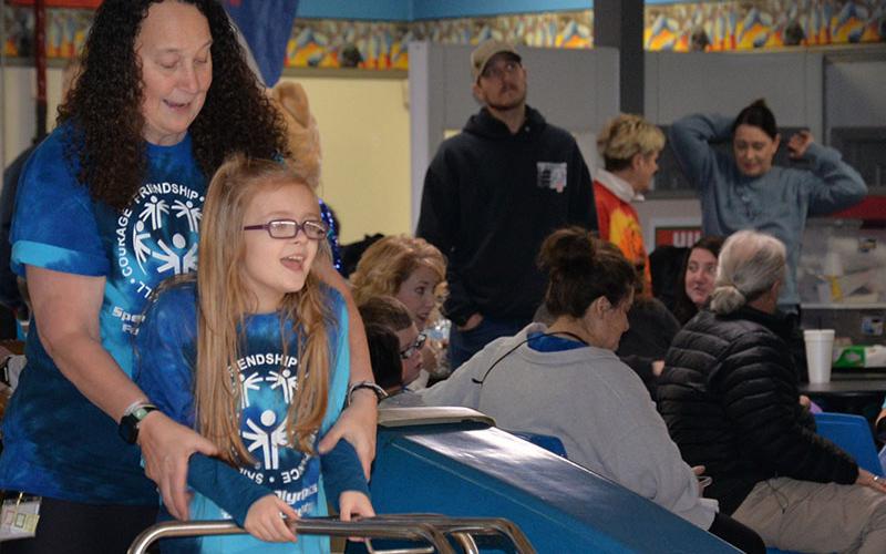 East Fannin’s Kinsley Marlow gets bowling help from paraprofessional Susan Jones.
