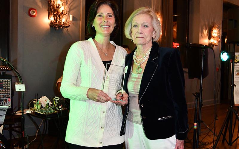 Sha Frazier, left, received accepted the Snack in a Backpack Children’s Champion award on behalf of her late husband, A.D. Frazier Jr. from Toots Greene, a Snack board member.