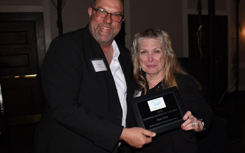 Pam Fink received the Outstanding Chamber Member award from Troy Shirbroun.