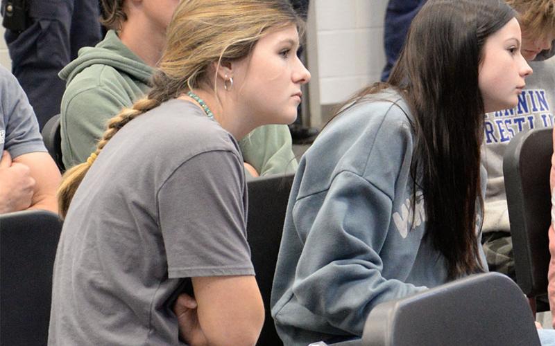 Emma Coffey, left, and Sarah Brawley watch closely as a trauma team treats a teenage girl seriously injured in a car crash. The scene was part of the Safe Driving Summit at Fannin County High School sponsored by the Lutzie 43 Foundation and Georgia Department of Transportation.