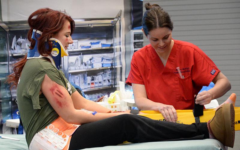 Thankfully, it wasn’t real. Emily Parker, RN, CCRN, from Erlanger Medical Center played the role of a teenage girl seriously injured in a car crash. Wheeled into the “trauma room” at Fannin County High School, students received a first hand view of a life-threatening situation.