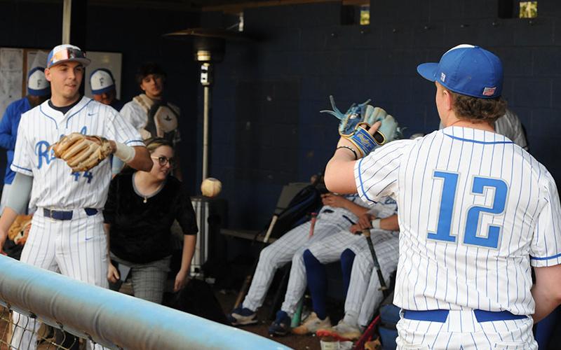 Gavin Davis, left, and Eli Queen, right, practice as they wait for weather to clear for a game scheduled March 13.