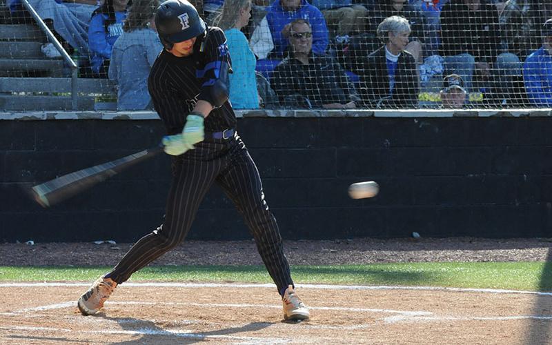 Gavin Davis takes a swing at an April 15 home baseball game.