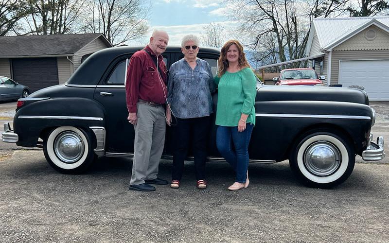 From left, Don Teffeteller, Imogene Teffeteller and Donna Neal stand in front of Imogene’s restored 1949 Plymouth.
