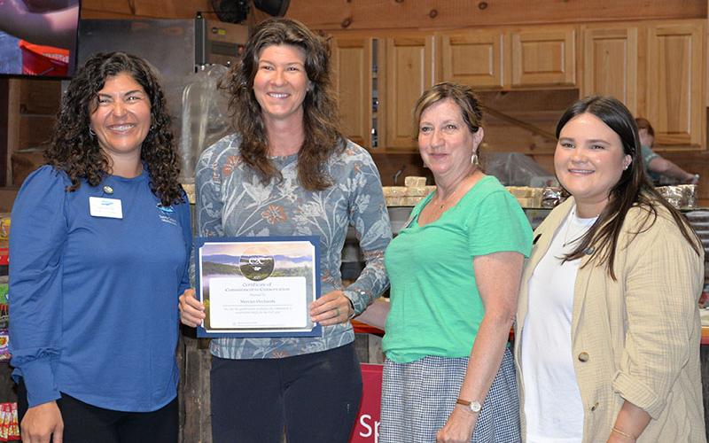 Fannin County Chamber of Commerce President Christie Gribble, left, presents Ashley Hoppers, of Mercier Orchards, with a certificate in recognition of their Commitment to Conservation Tuesday, April 22. They are also shown with, from left, Becky Griffin and Emily Owenby.