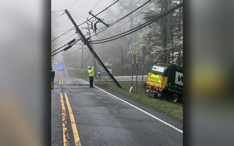 Friday’s early morning fog was still visible when Tri-State EMC crews began restoring an extensive power outage when the truck at right went through the stop sign at the intersection of State Route 60 and Old Highway 76.