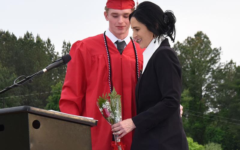 CBHS Principal Holly Smith received a ceremonial rose from her son, Talon, recognizing him as the last child in the family to graduate from high school.