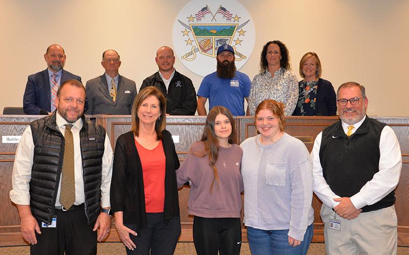 Fannin County High School’s HOSA was celebrated at the Board of Education’s April 10 meeting. Shown are, from left, front, Principal Dr. Scott Ramsey, teacher Anne Gibbs, Bailey Gaddis, Cassidy Walden and CTAE Supervisor David Henson; back, board members, Chairman Mike Cole, Bobby Bearden, Adam Born, Robert Patterson, Ashley Herendon-Weeks and Superintendent Shannon Dillard.