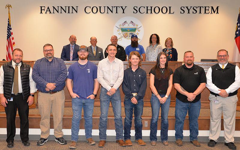Fannin County High School Skills USA team members were honored at the Board of Education’s April 10 meeting. Shown are, from left, front, Principal Dr. Scott Ramsey, teacher Devin Dilbeck, Harlan Nelson, River Stuart, Trenten Flowers, Bailee Stiles, teacher Terry Flowers, and CTAE Supervisor David Henson; behind, board members, Chairman Mike Cole, Bobby Bearden, Adam Born, Robert Patterson, Ashley Herendon-Weeks and Superintendent Shannon Dillard.