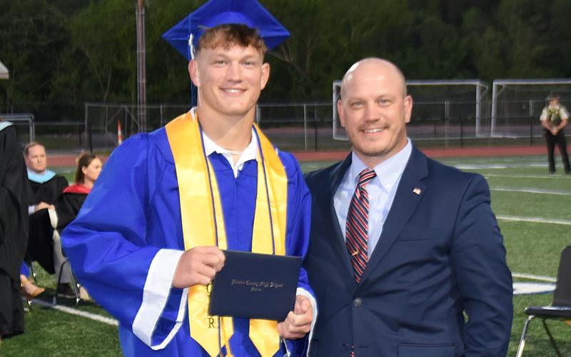 Cooper Born was congratulated by his father, Adam Born, moments after being presented his diploma.