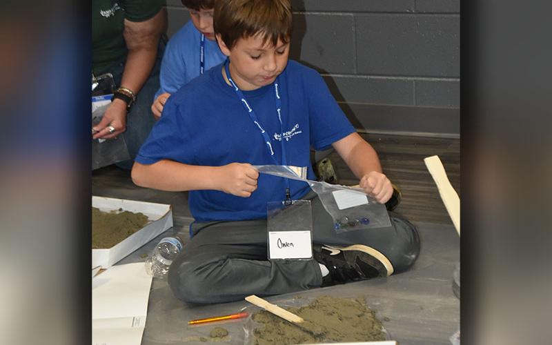 Owen Mull works on his masterpiece during this year’s Camp Cocoon.
