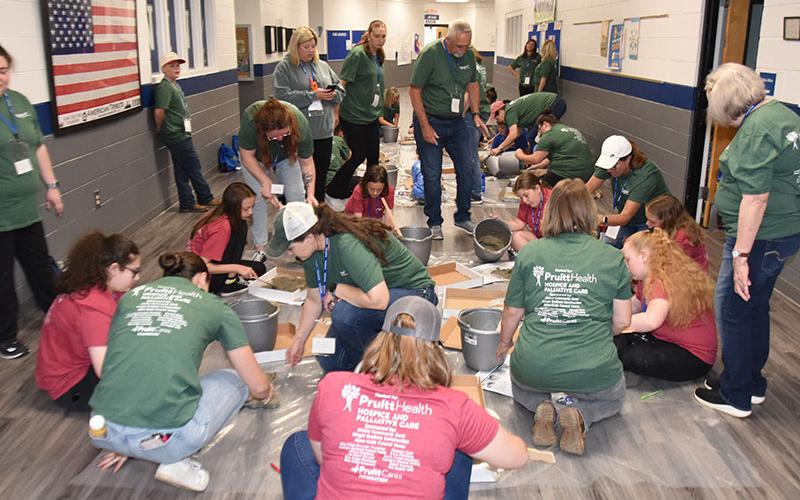 Memory stones took a lot of work by youngsters and volunteers alike during Camp Cocoon. This was the scene Saturday morning, May 3, during the annual event sponsored by PruittHealth Hospice.