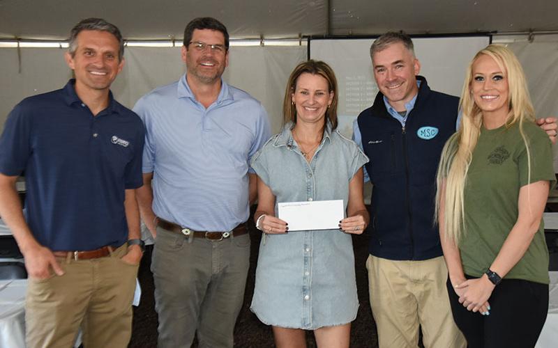 Monica Farrow, center, displays a $2,500 check donated to the Copper Basin High School Scholarship Committee from Hedrick Industries. Also shown are, from left, Joe Lordi, president and CEO of Hedrick Industries; Jason Conner, vice president of Land Management; Farrow, who is a member of the Copper Basin Scholarship Committee; Jon Neumann, vice president of Material Sales Company; and Polk County District Three Commissioner Samantha Trantham.