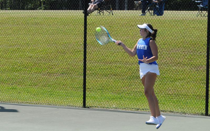 Lady Rebel Sadie Patton jumps to return a ball in an April 30 tennis match at Fannin County High School.