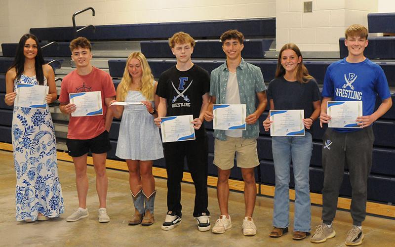 Wrestling team members receive academic awards April 28. From left, Emma Shaw, Landon Poole, Venice Oliver, Bentlee Jackson, Conrad Head, Makenzie Duvall and Copland Thomas.