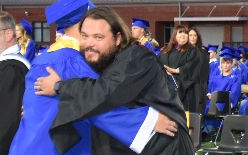 Fannin County High School Athletic Director Jeremy King gave this graduate a big hug as he praised him for his success.
