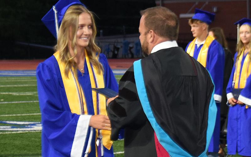 Kayla Hughes, like every member of the Class of 2025, is congratulated by Fannin County High School Principal Dr. Scott Ramsey.