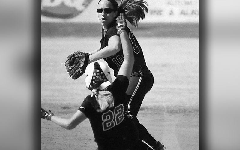 Karly Thompson comes from her shortstop position to turn a double play.