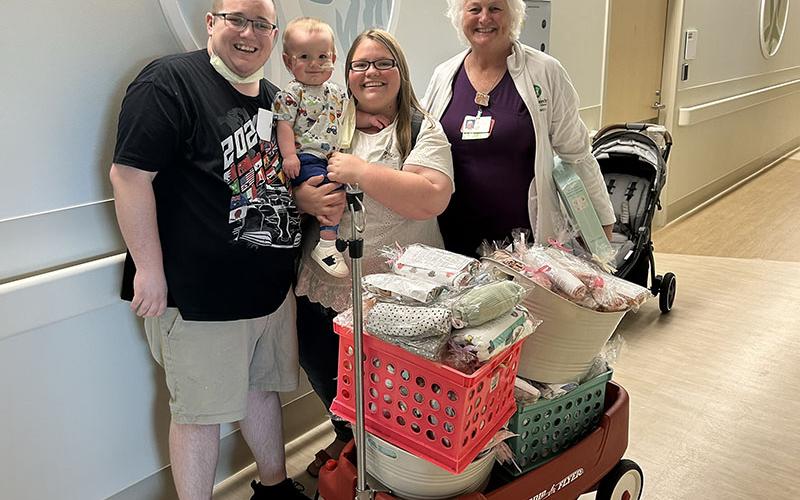 The Giddens family, Erik, Jax and Kayla, from left, are shown with one of their nurses at the Children’s Healthcare of Atlanta while delivering blankets.